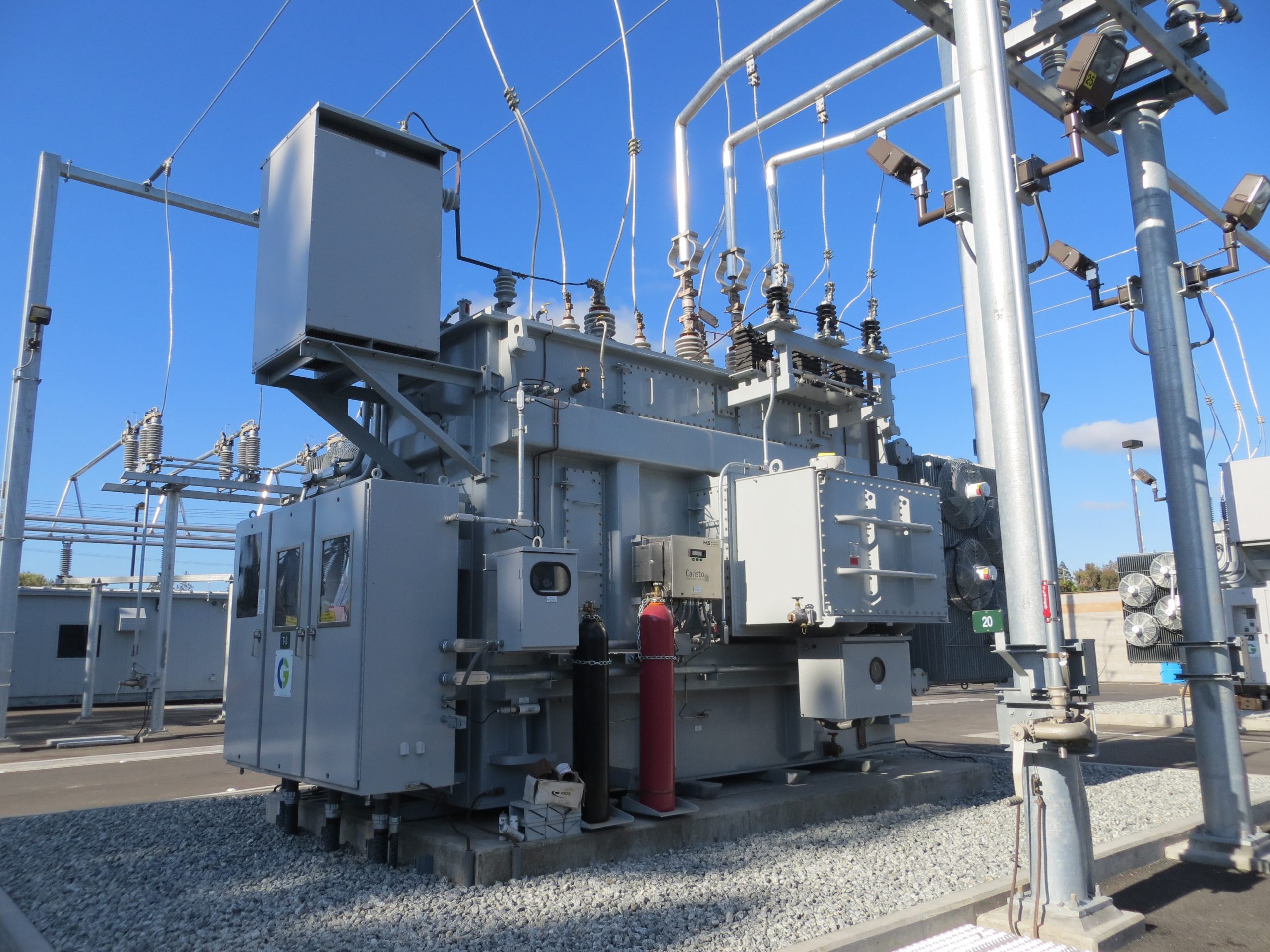 Grey Electric Power Generator Connected to Metal Poles and Wires.