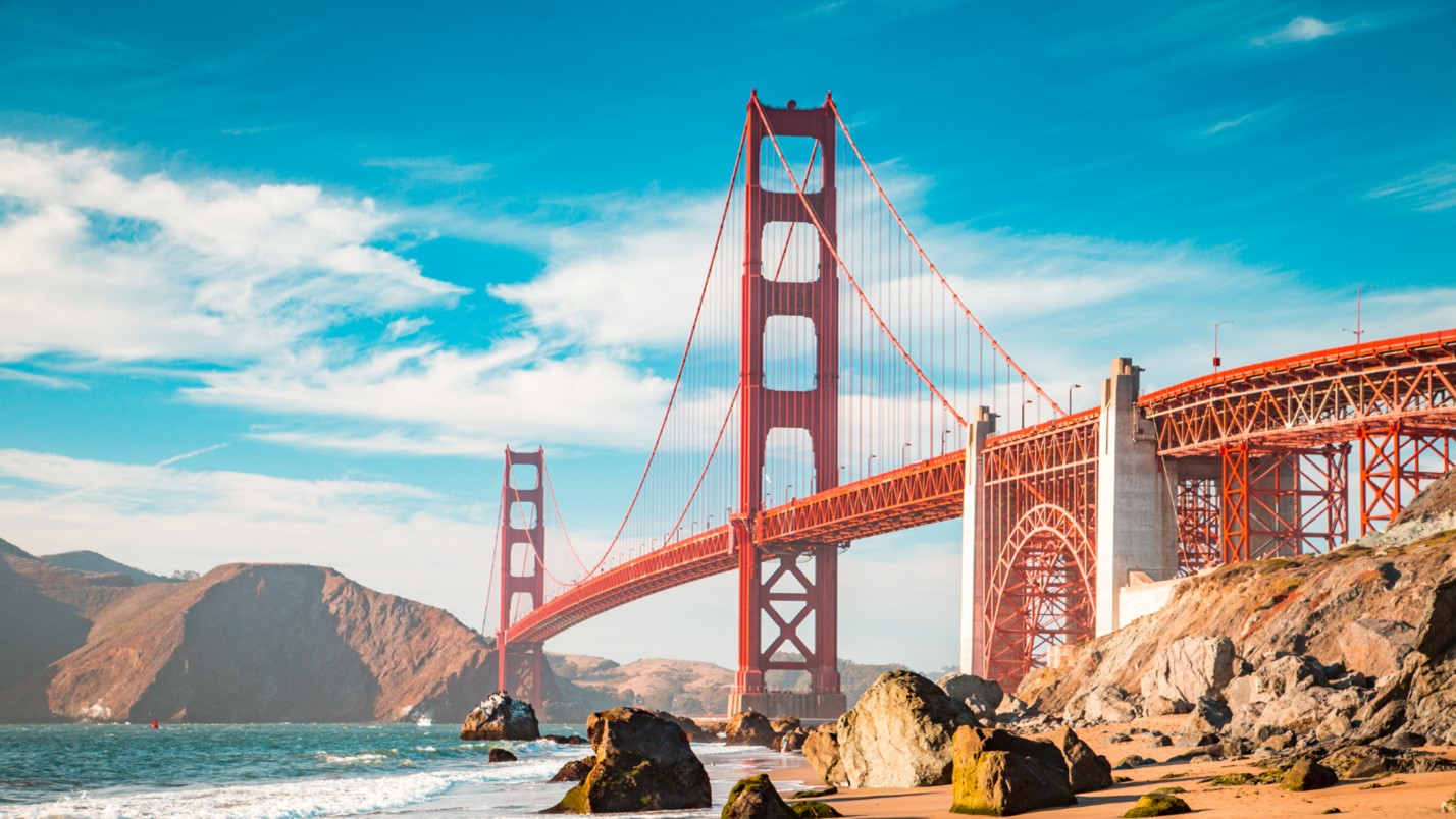 A View of the Golden Gate Bridge With the Ocean Shore and Mountains.