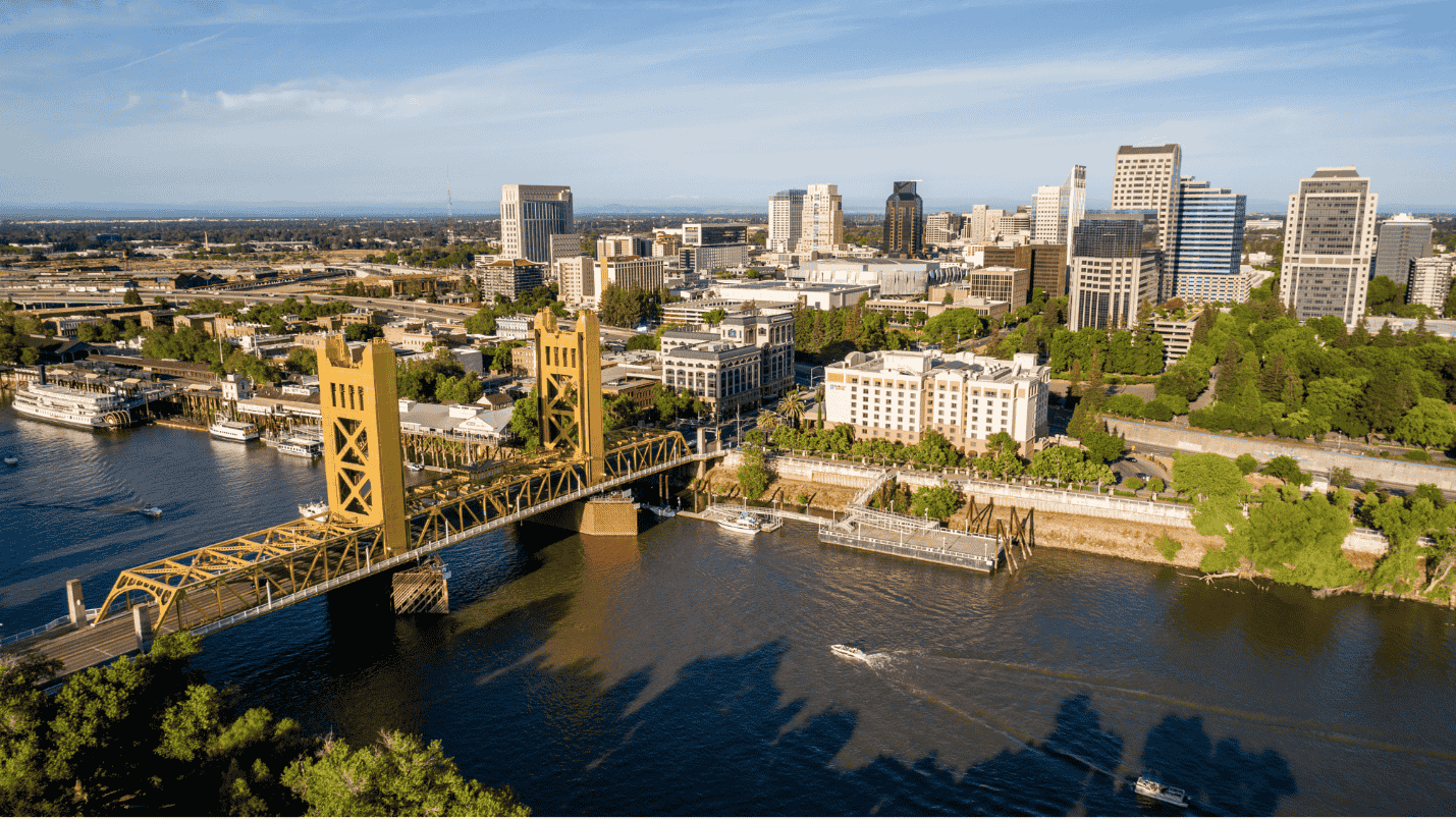 A wide view of the city of Sacramento including the local river.